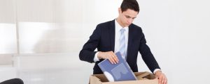 corporate employee packing box in cubicle
