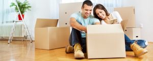 Couple unboxing items in empty apartment