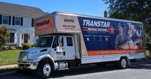 Transtar moving truck in neighborhood
